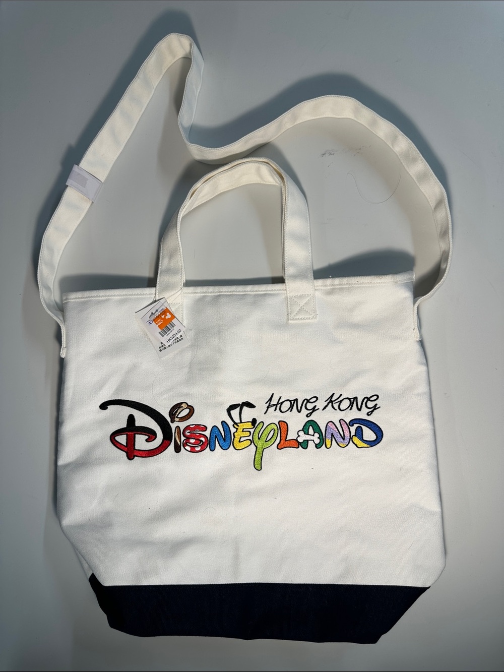 Disney White Canvas Crossbody Tote with Multicolor Hong Kong Disneyland Logo NWT
